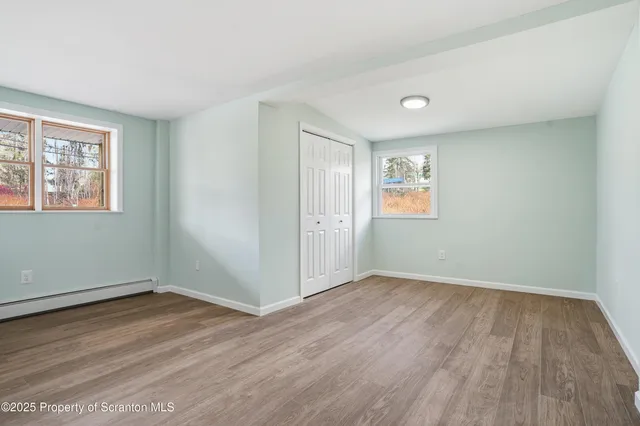 an empty room with wooden floor