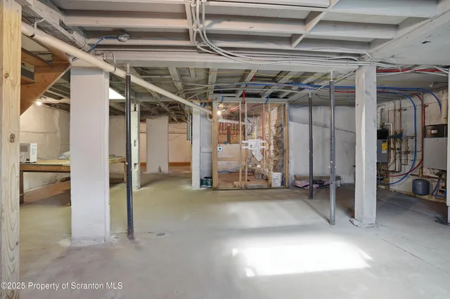 a view of a hallway with wooden floor and windows