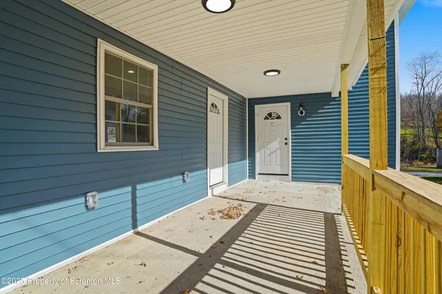a kitchen with white cabinets and appliances