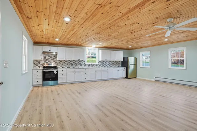 a kitchen with stainless steel appliances granite countertop a refrigerator sink and cabinets