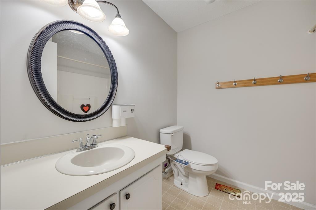 810 Applegate Court Gastonia, NC 28054 - Photo 18 of 31 a bathroom with a toilet a sink and a mirror