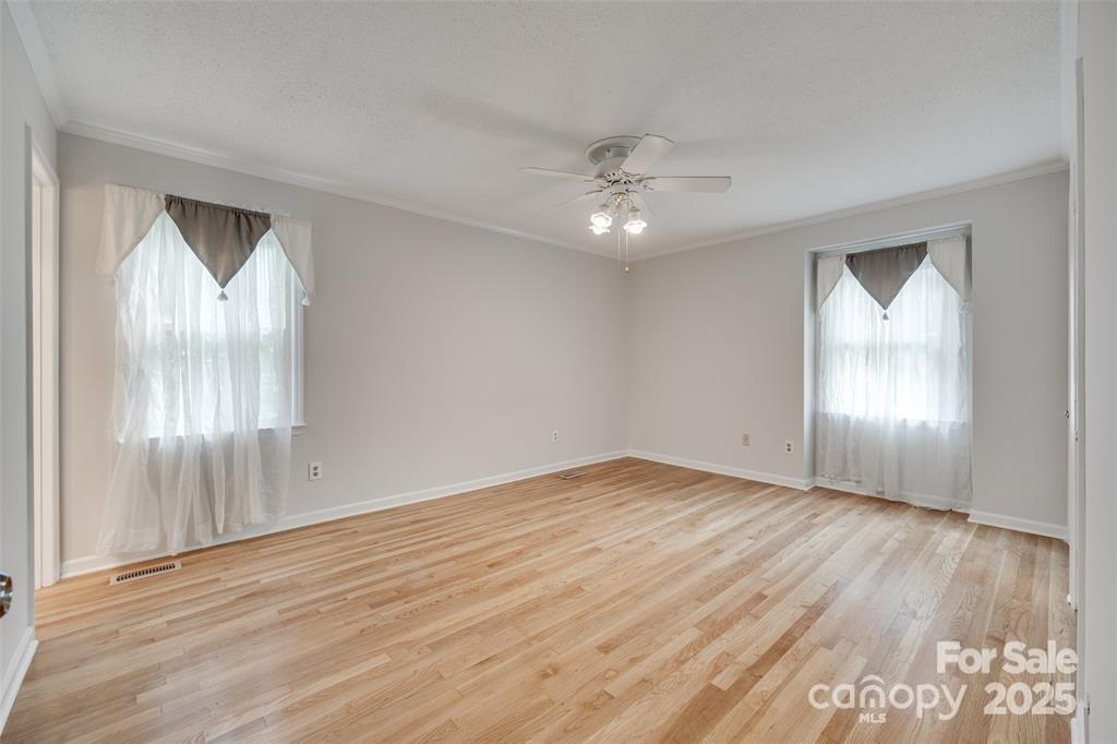 810 Applegate Court Gastonia, NC 28054 - Photo 19 of 31 an empty room with wooden floor fan and windows
