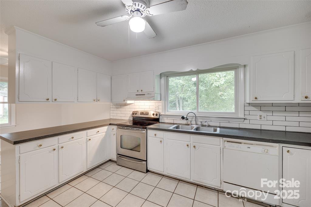810 Applegate Court Gastonia, NC 28054 - Photo 7 of 31 a kitchen with white cabinets appliances and a window