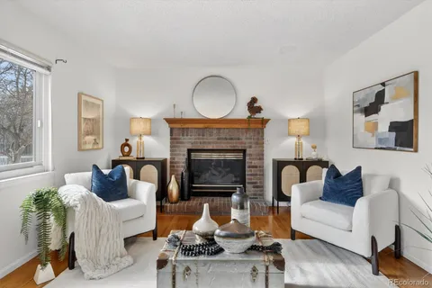 a living room with furniture fireplace and window