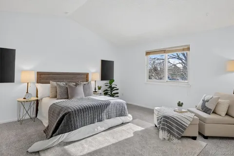 a bedroom with a bed and a couch