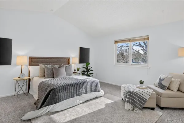 a bedroom with a bed and a couch