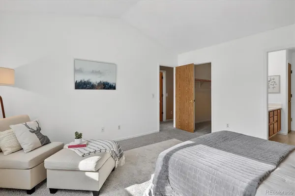 a bedroom with a bed and a couch