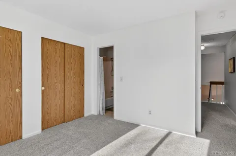 a view of a room with a hallway and closet