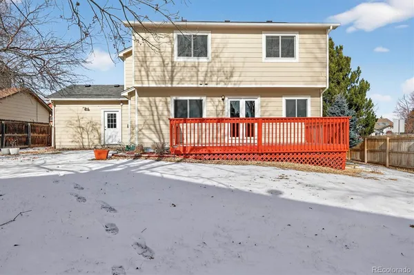 a view of a house with wooden fence