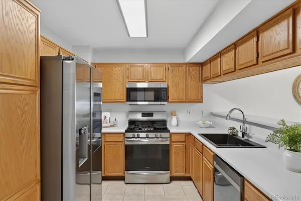 a kitchen with a sink a stove and refrigerator