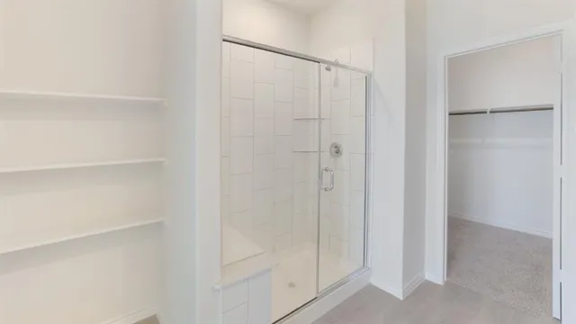 a bathroom with a glass shower door