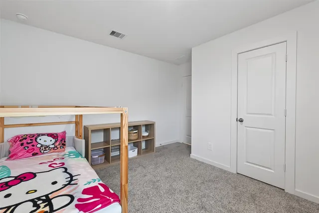 a living room with furniture a baby crib and a couch