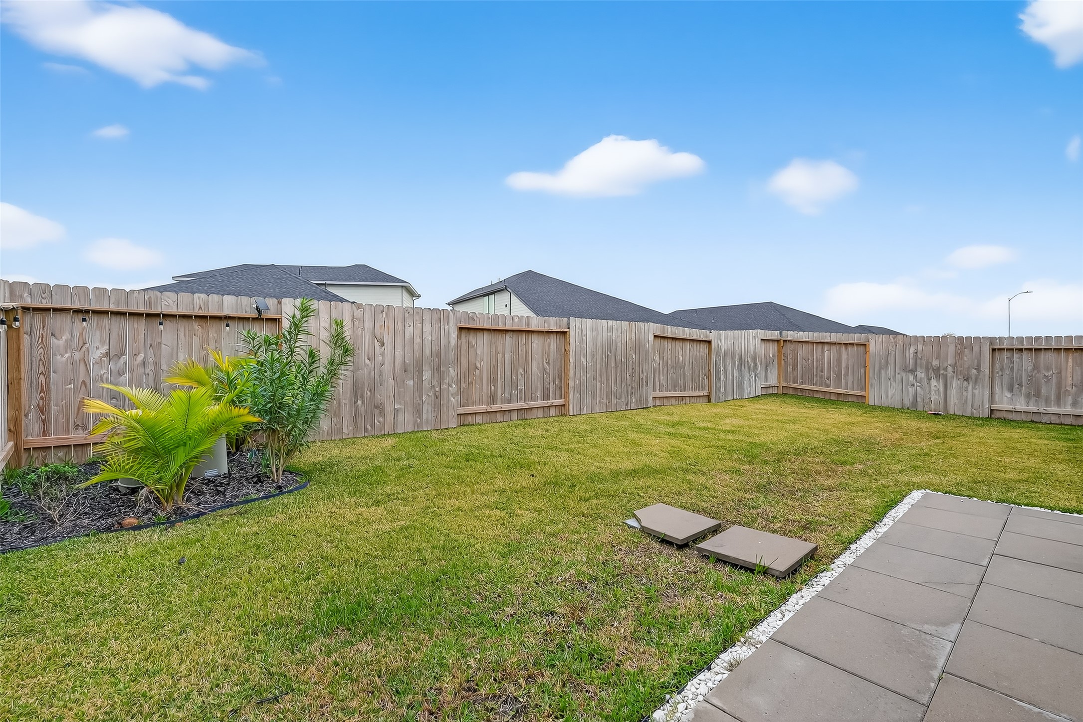 3903 Dodington Ash Drive Fulshear, TX 77441 - Photo 42 of 46 a view of a backyard with a garden and outdoor seating