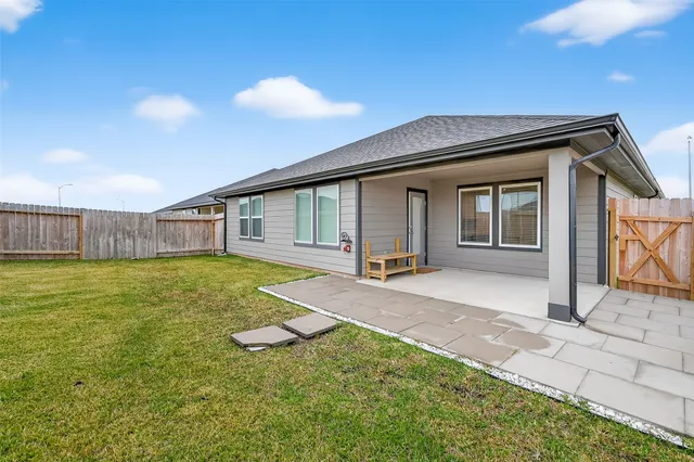 a view of a house with backyard and porch