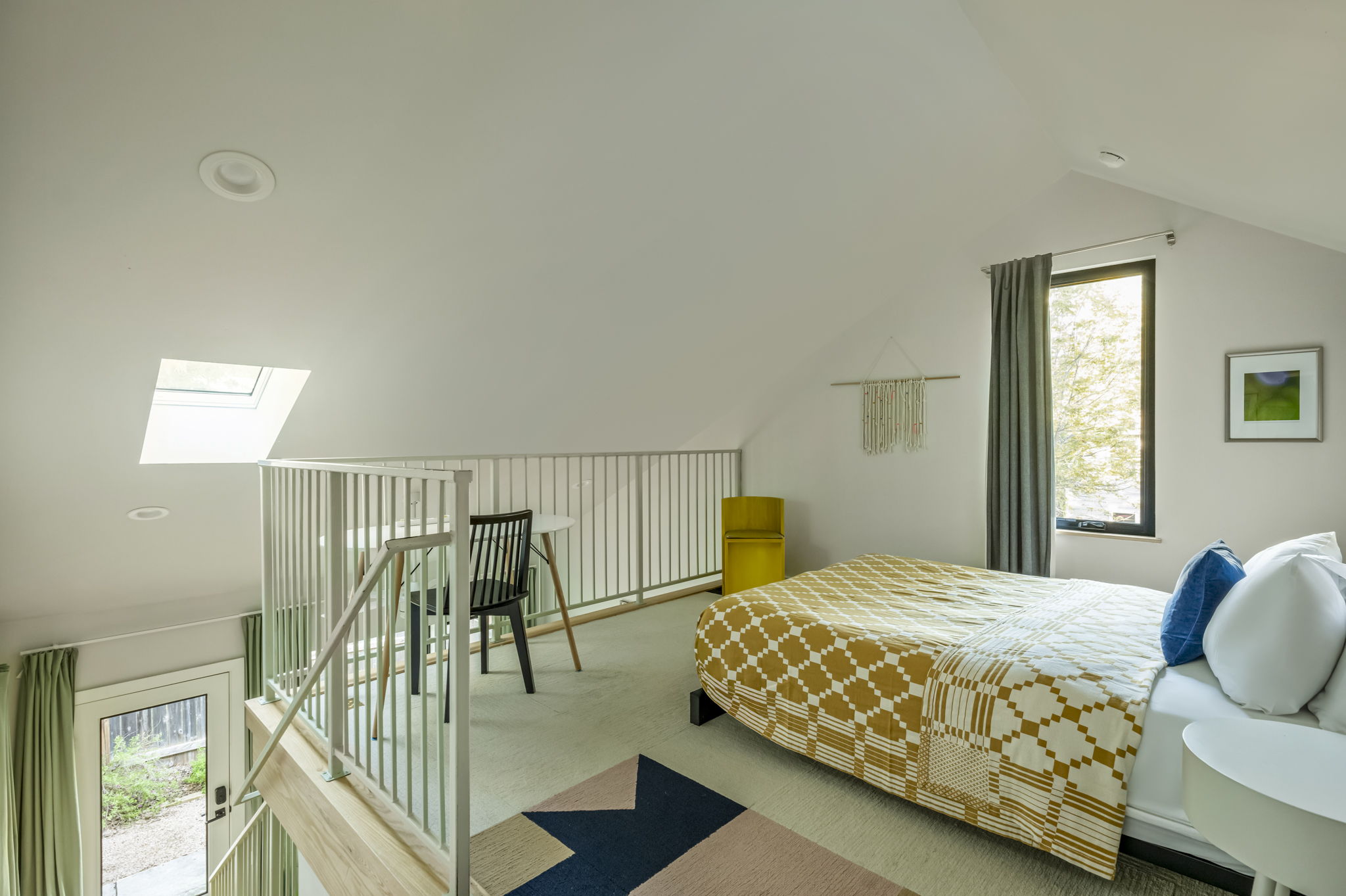 618 Denson Drive Austin, TX 78752 - Photo 31 of 35 a bedroom with a bed and large windows