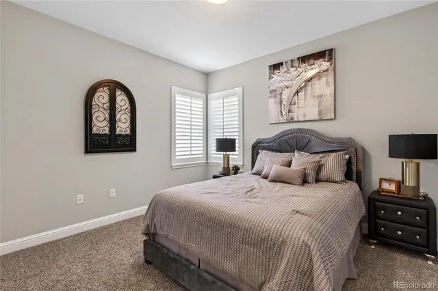 a bedroom with a bed and a painting on the wall