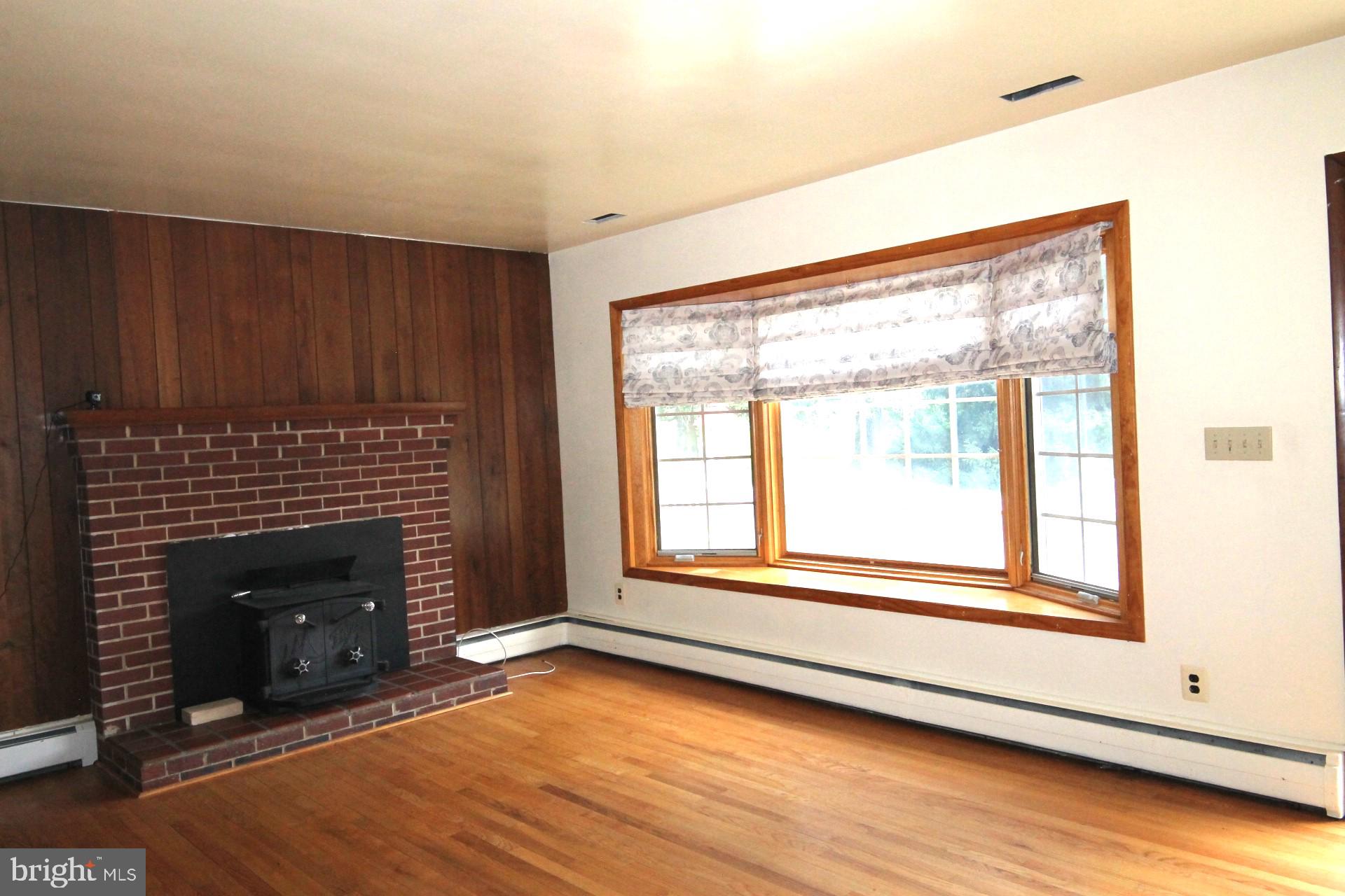 5010 Wards Chapel Road Reisterstown, MD 21136 - Photo 10 of 34 Living room with hardwood floors n wood fireplace