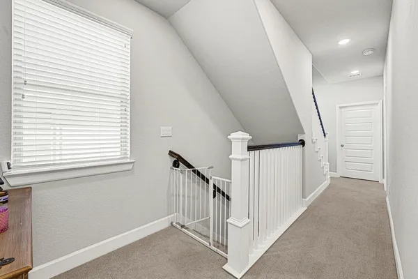 a view of a hallway with windows