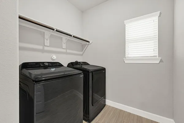 a view of storage and utility room with washer and dryer