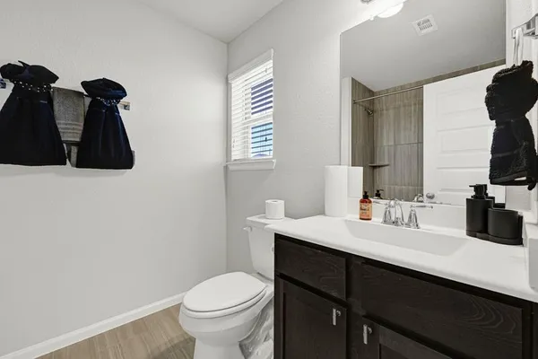 a bathroom with a sink a toilet and mirror