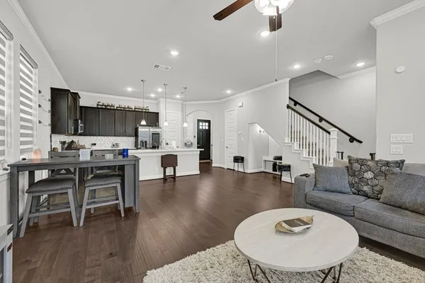 a living room with furniture and kitchen view
