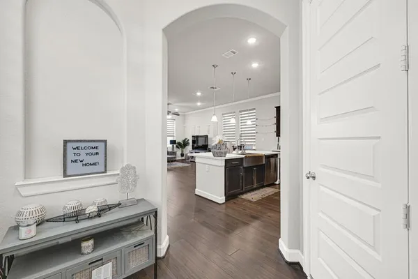 a kitchen with stainless steel appliances wooden floor and stove