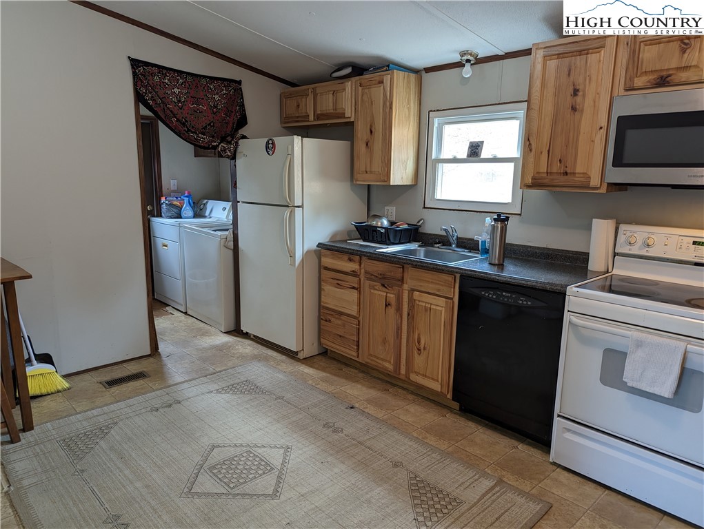 330 Sugarworth Mountain Road Boone, NC 28607 - Photo 26 of 43 a kitchen with a refrigerator stove and sink