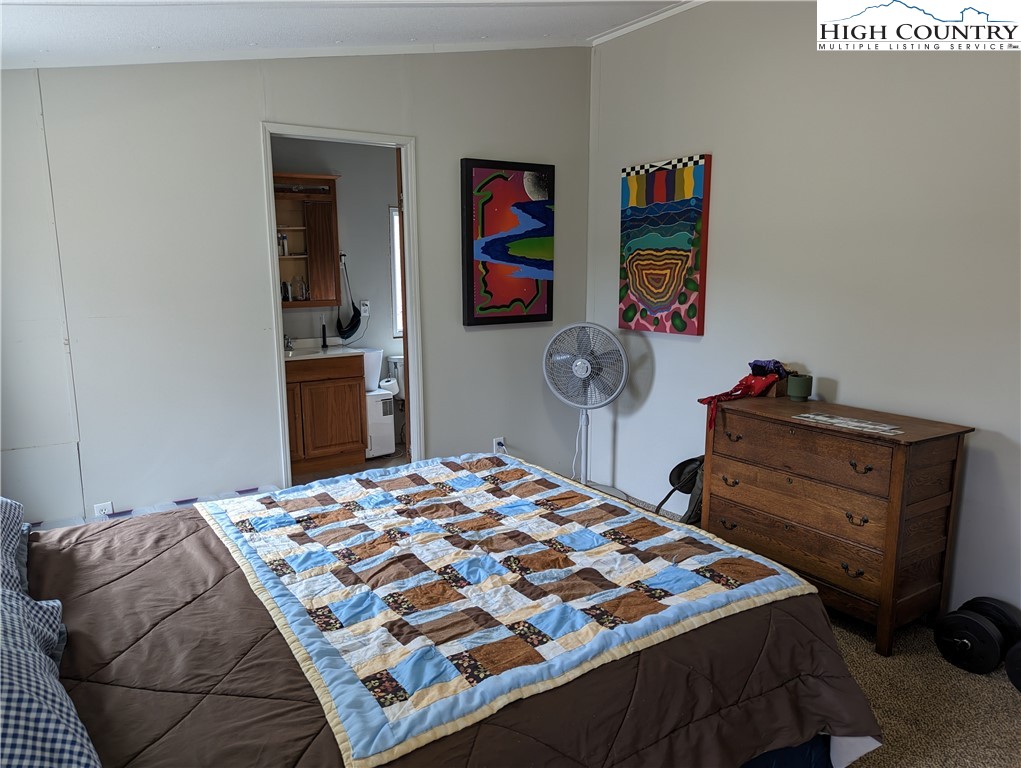 330 Sugarworth Mountain Road Boone, NC 28607 - Photo 28 of 43 a bedroom with a bed and dresser