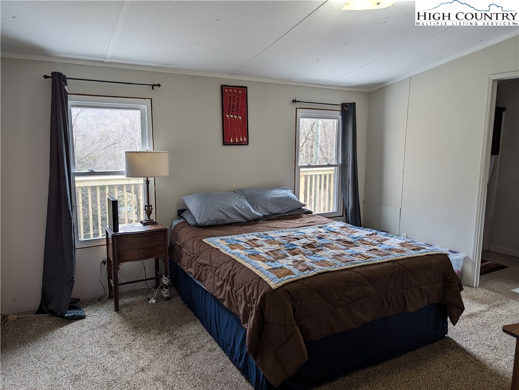 330 Sugarworth Mountain Road Boone, NC 28607 - Photo 29 of 43 a bedroom with a bed and a window