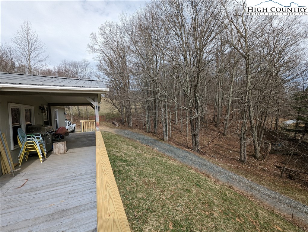 330 Sugarworth Mountain Road Boone, NC 28607 - Photo 3 of 43 a view of house with deck outdoor seating and covered with trees