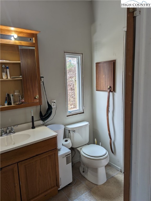 330 Sugarworth Mountain Road Boone, NC 28607 - Photo 31 of 43 a bathroom with a toilet sink and mirror