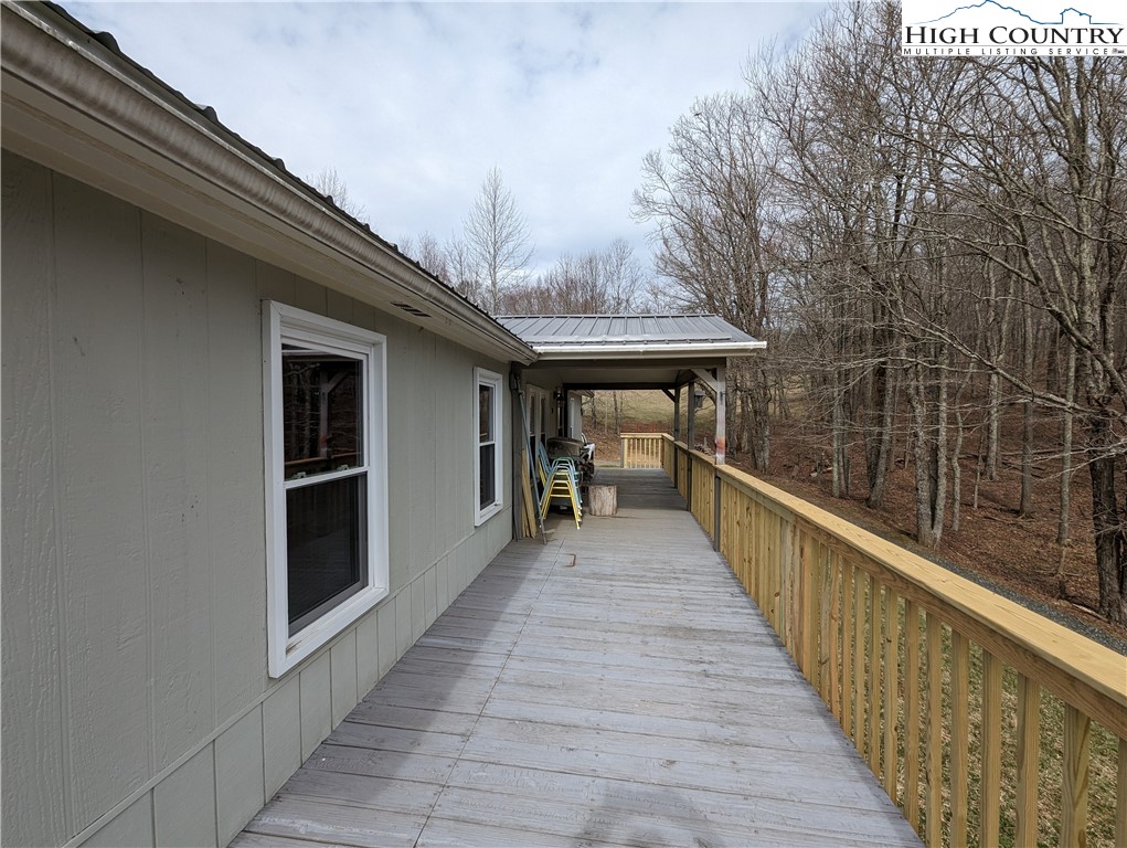 330 Sugarworth Mountain Road Boone, NC 28607 - Photo 5 of 43 a view of a balcony with wooden floor and barbeque oven