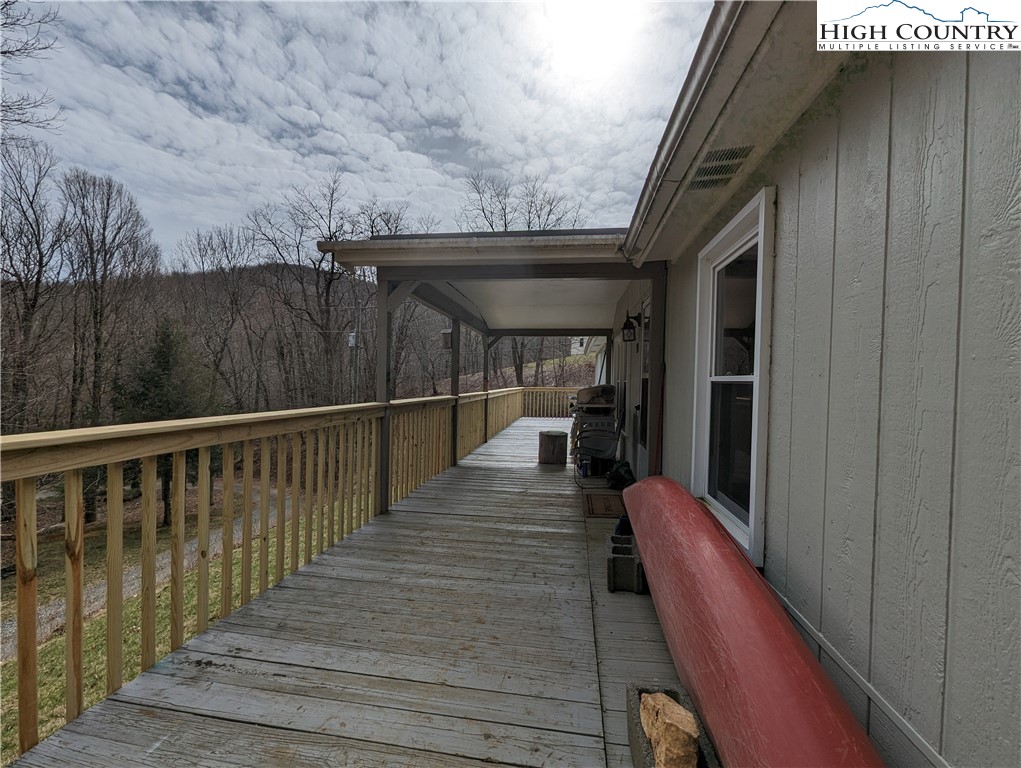 330 Sugarworth Mountain Road Boone, NC 28607 - Photo 6 of 43 a view of a balcony with wooden floor and seating space