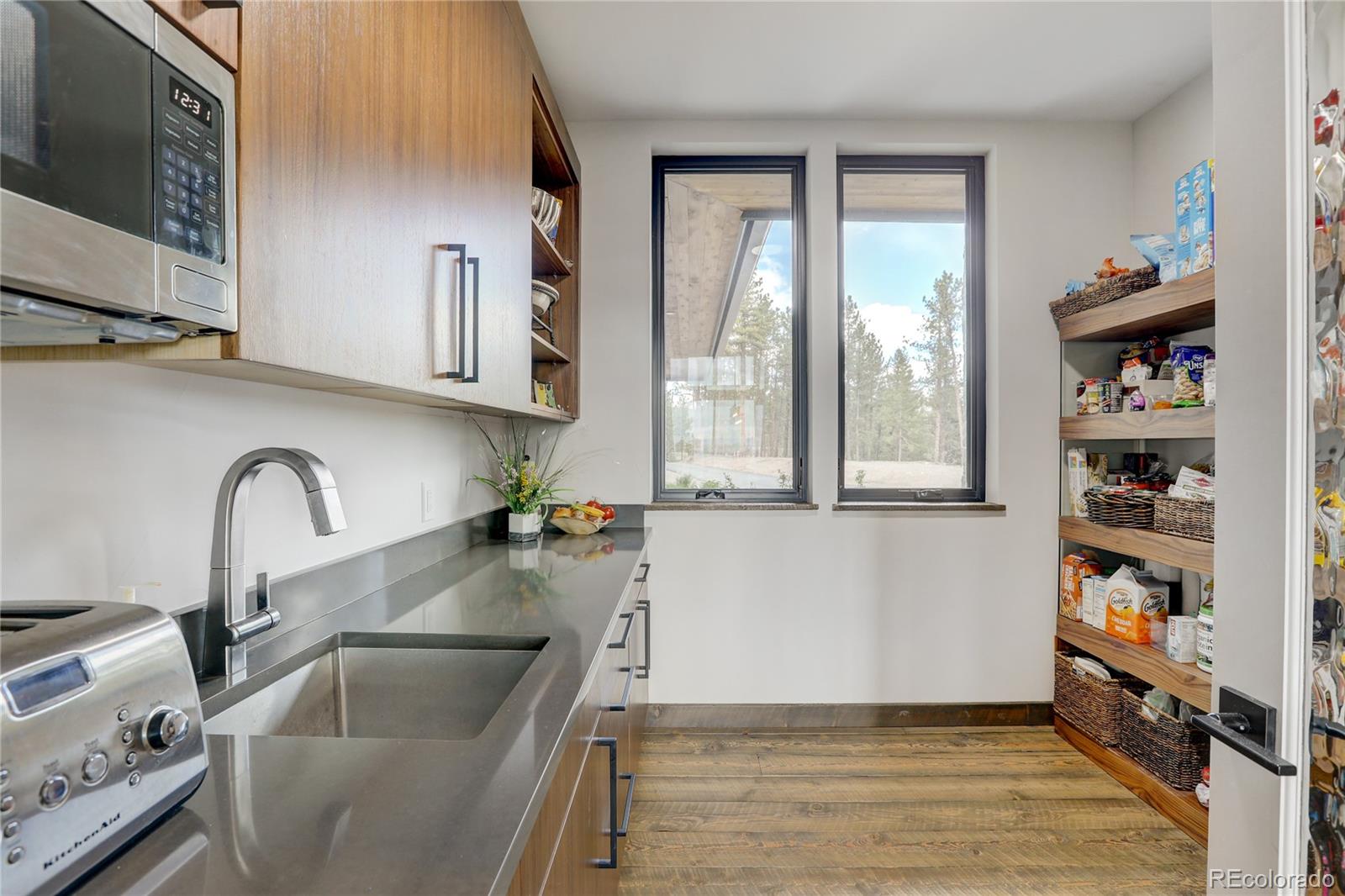 31995 Half Peak Trail Pine, CO 80470 - Photo 13 of 40 a kitchen with granite countertop a sink a stove and cabinets