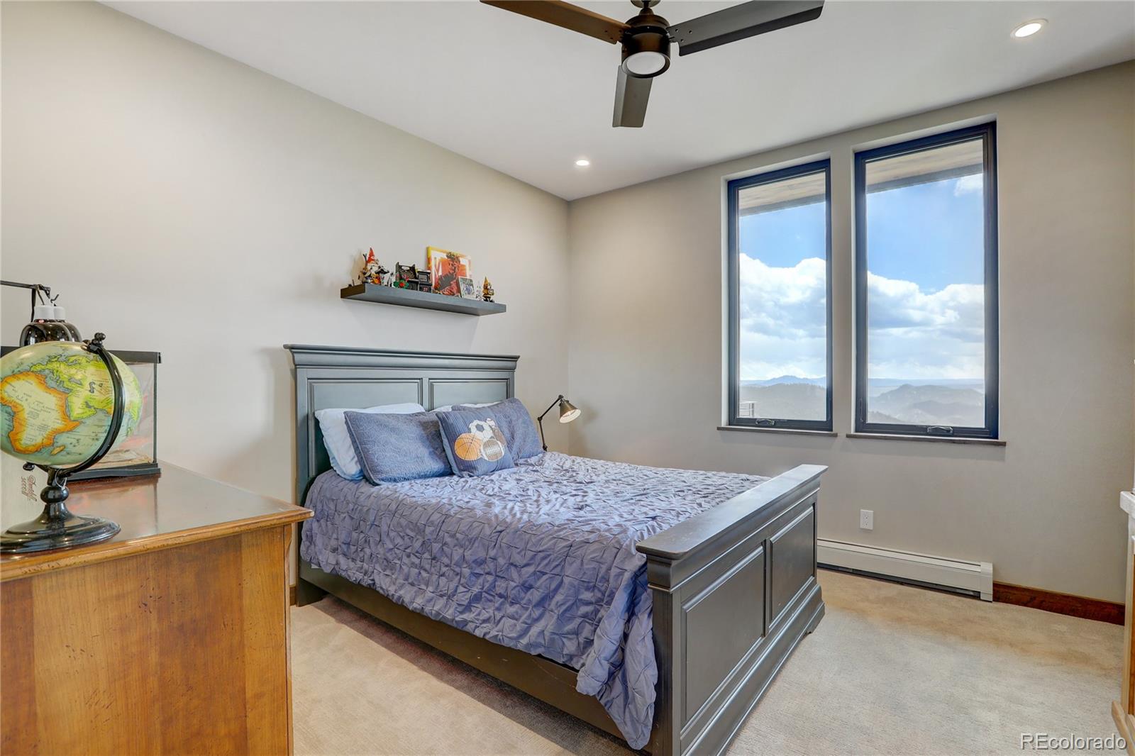31995 Half Peak Trail Pine, CO 80470 - Photo 20 of 40 a bedroom with a bed dresser and a window