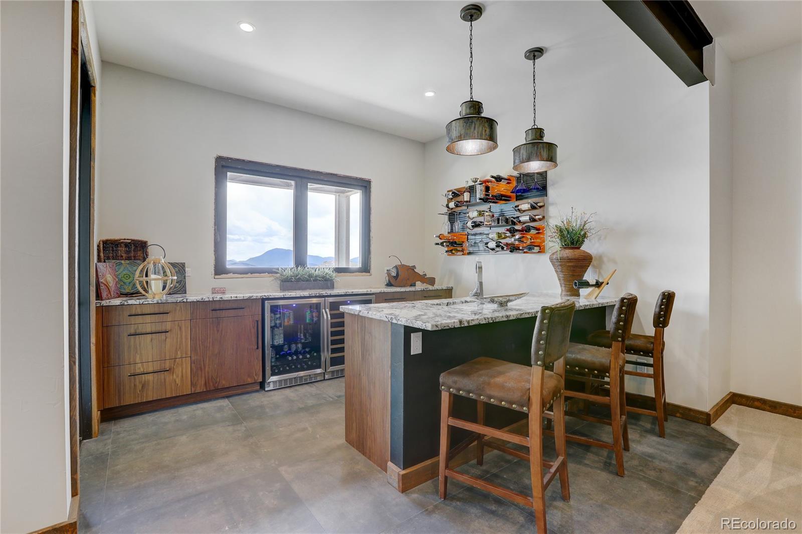 31995 Half Peak Trail Pine, CO 80470 - Photo 26 of 40 a dining room with a table chairs and kitchen view