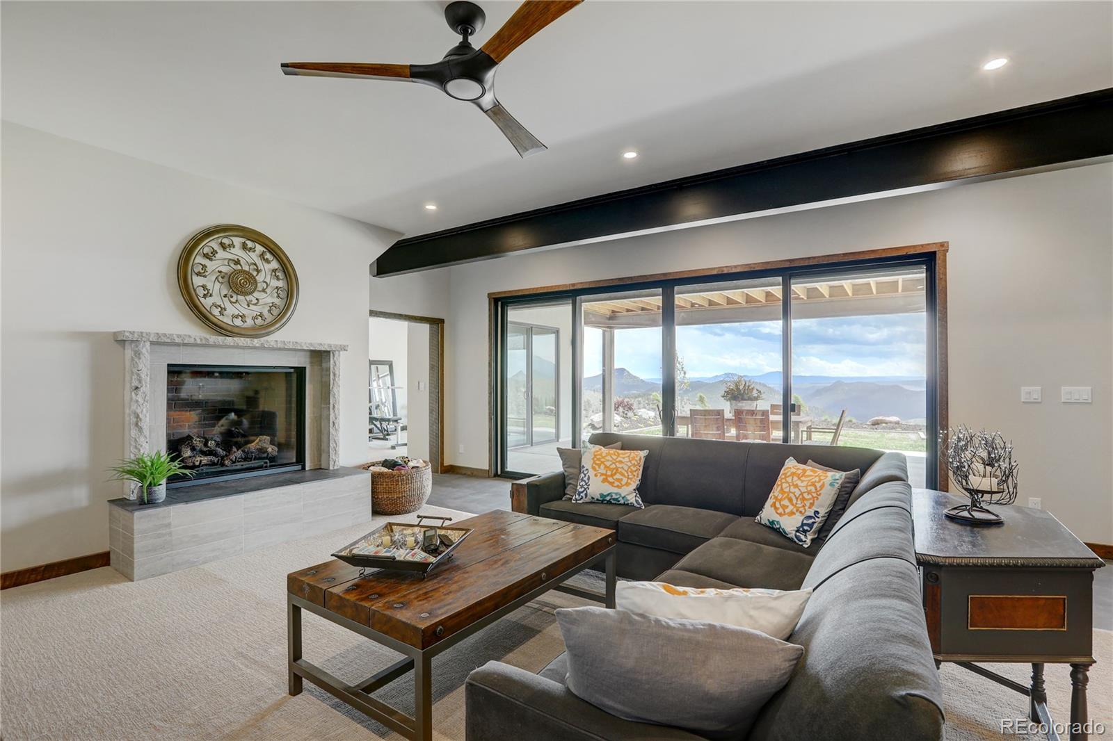 31995 Half Peak Trail Pine, CO 80470 - Photo 27 of 40 a living room with furniture and a fireplace