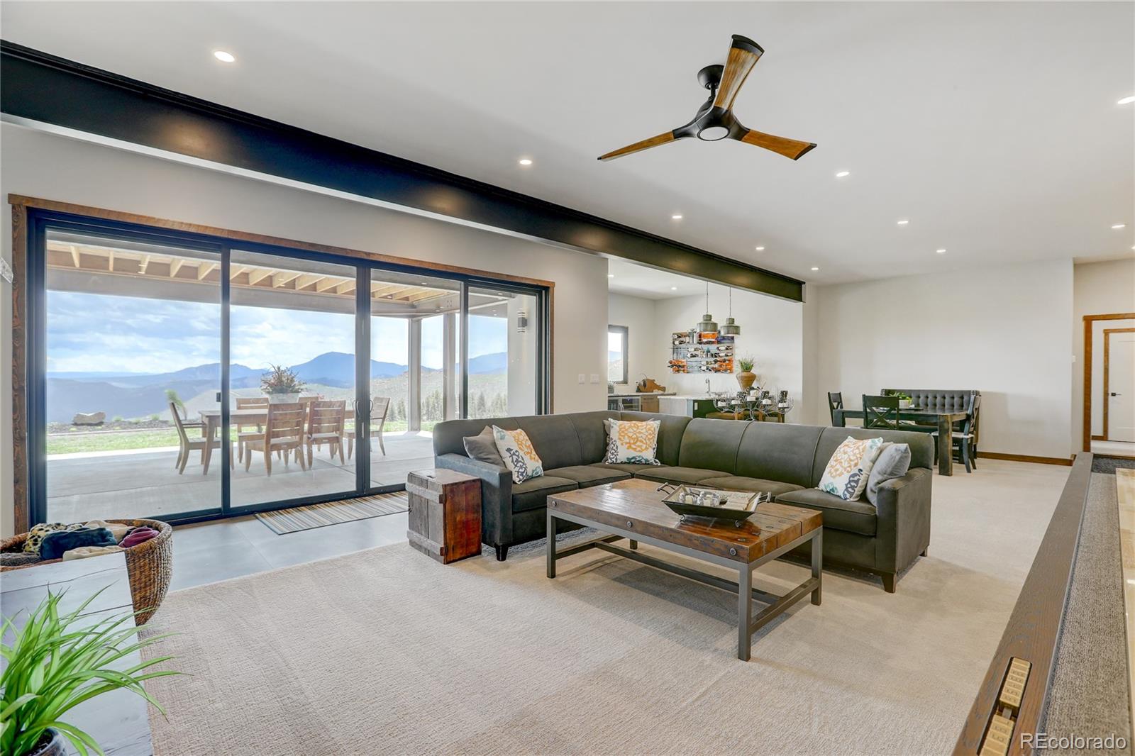 31995 Half Peak Trail Pine, CO 80470 - Photo 28 of 40 a living room with furniture and large windows