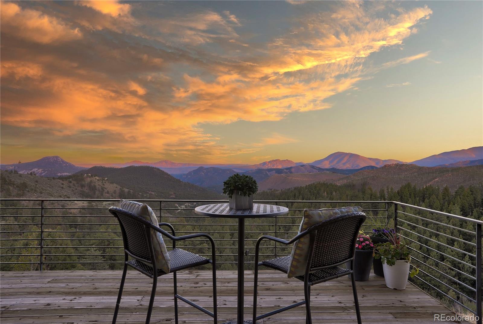 31995 Half Peak Trail Pine, CO 80470 - Photo 34 of 40 a view of a terrace with a table and chairs