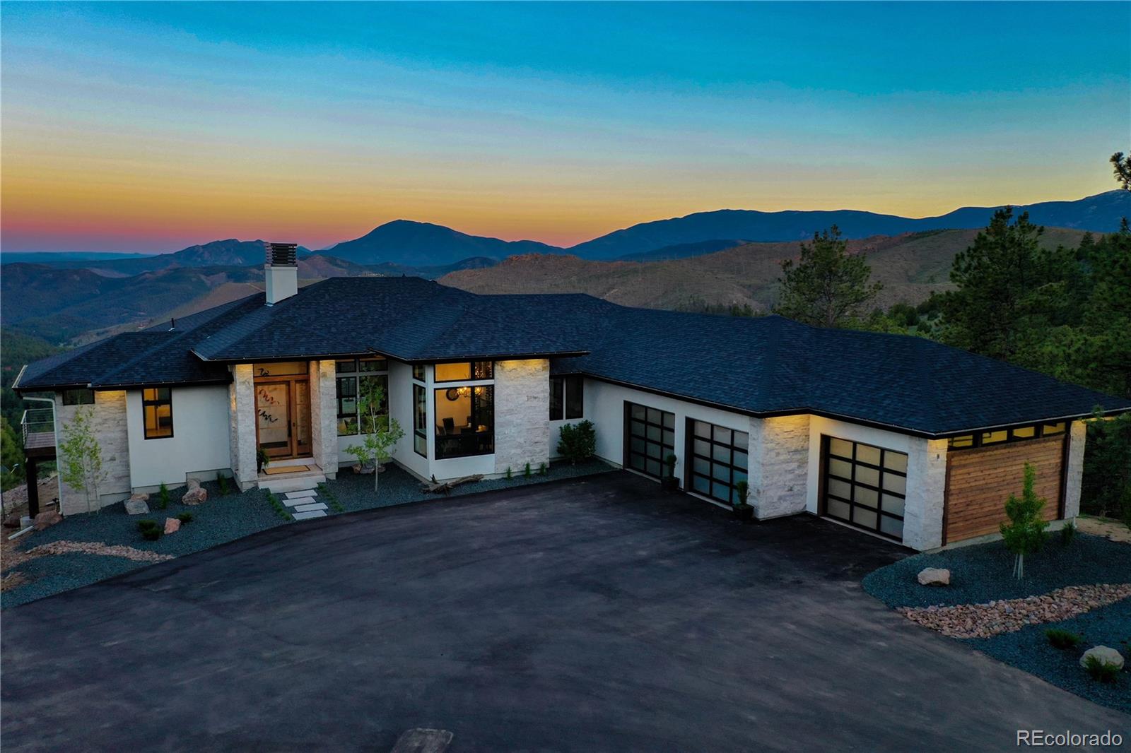 31995 Half Peak Trail Pine, CO 80470 - Photo 39 of 40 a view of a house with a yard and table