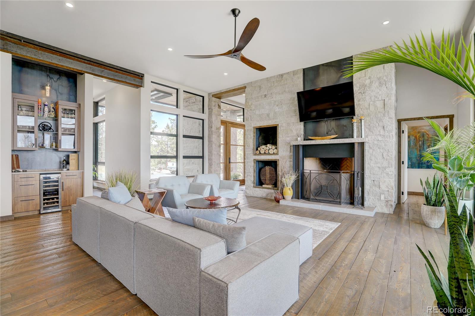 31995 Half Peak Trail Pine, CO 80470 - Photo 4 of 40 a living room with furniture and a fireplace