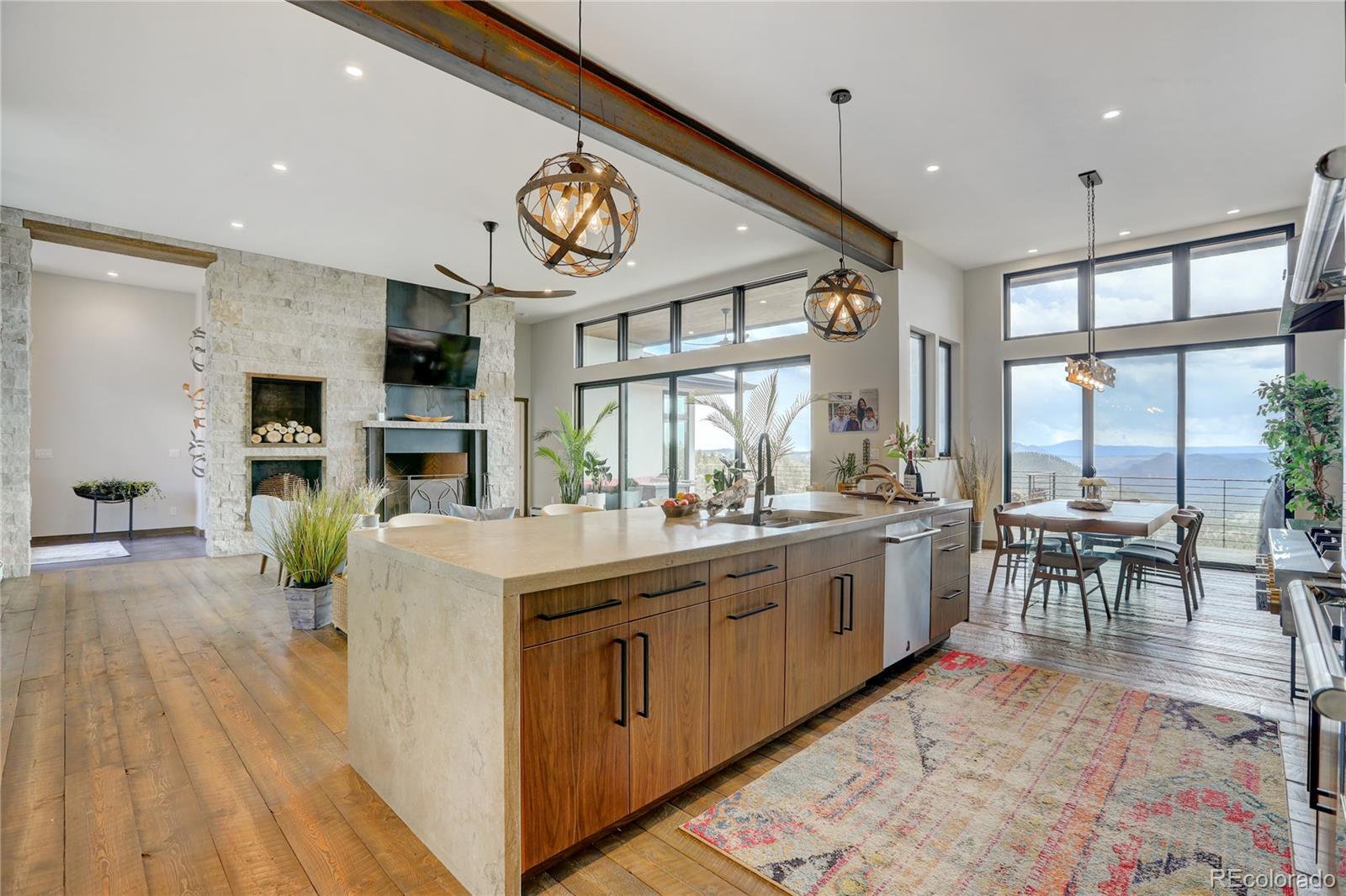 31995 Half Peak Trail Pine, CO 80470 - Photo 7 of 40 a large kitchen with kitchen island a large island in it