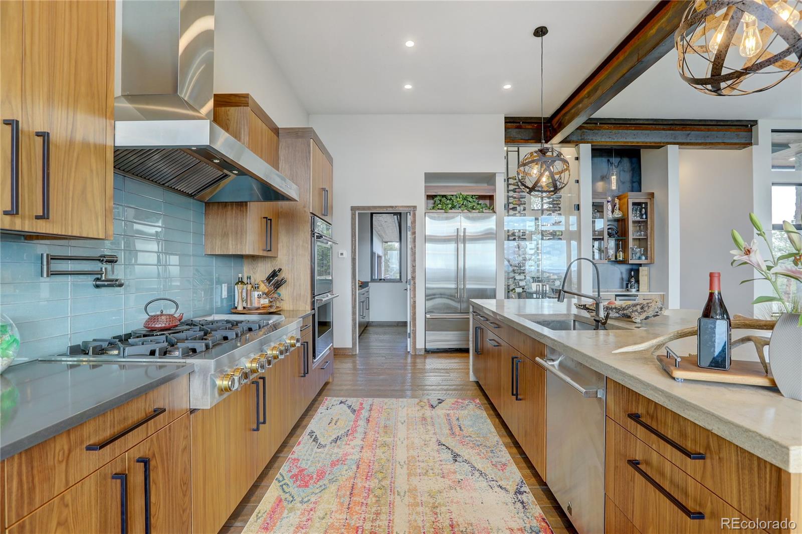 31995 Half Peak Trail Pine, CO 80470 - Photo 8 of 40 a kitchen with stainless steel appliances granite countertop a sink and cabinets
