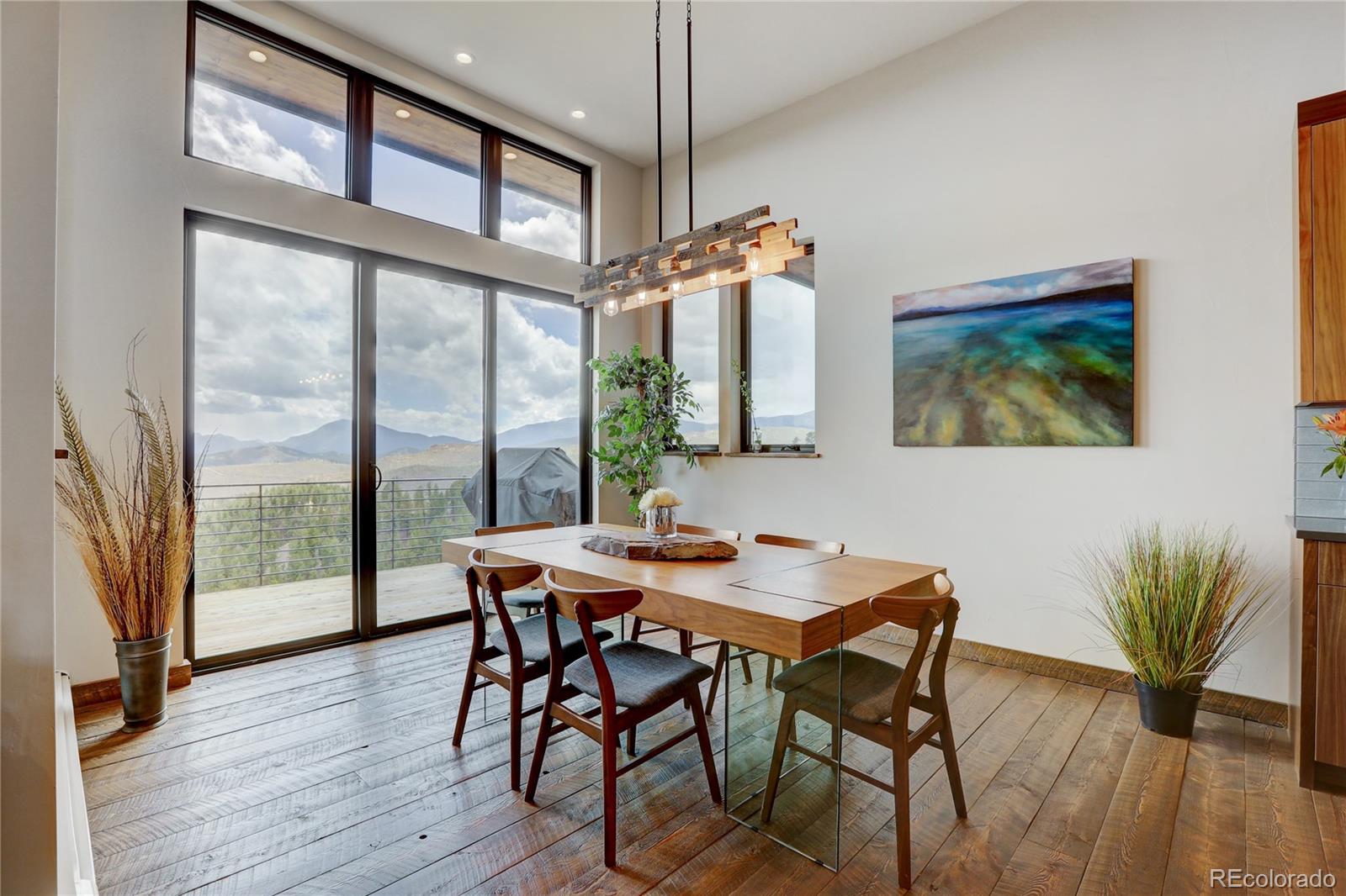 31995 Half Peak Trail Pine, CO 80470 - Photo 10 of 40 a view of a dining room with furniture window and wooden floor
