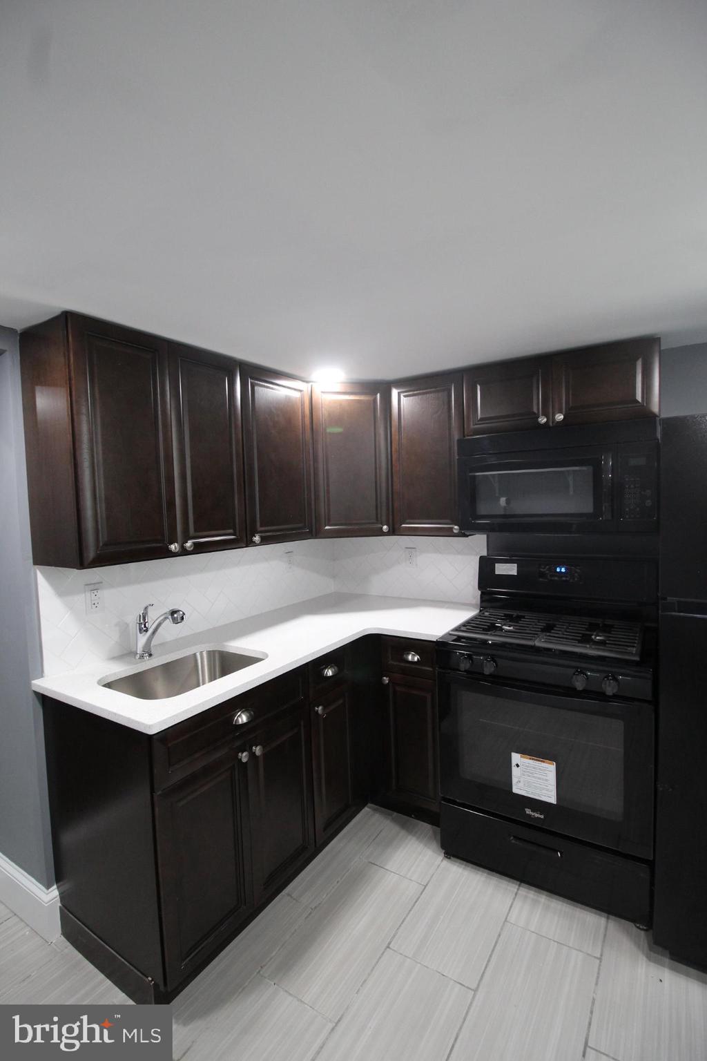 3086 Memphis Street Philadelphia, PA 19134 - Photo 6 of 18 a kitchen with a sink and cabinets