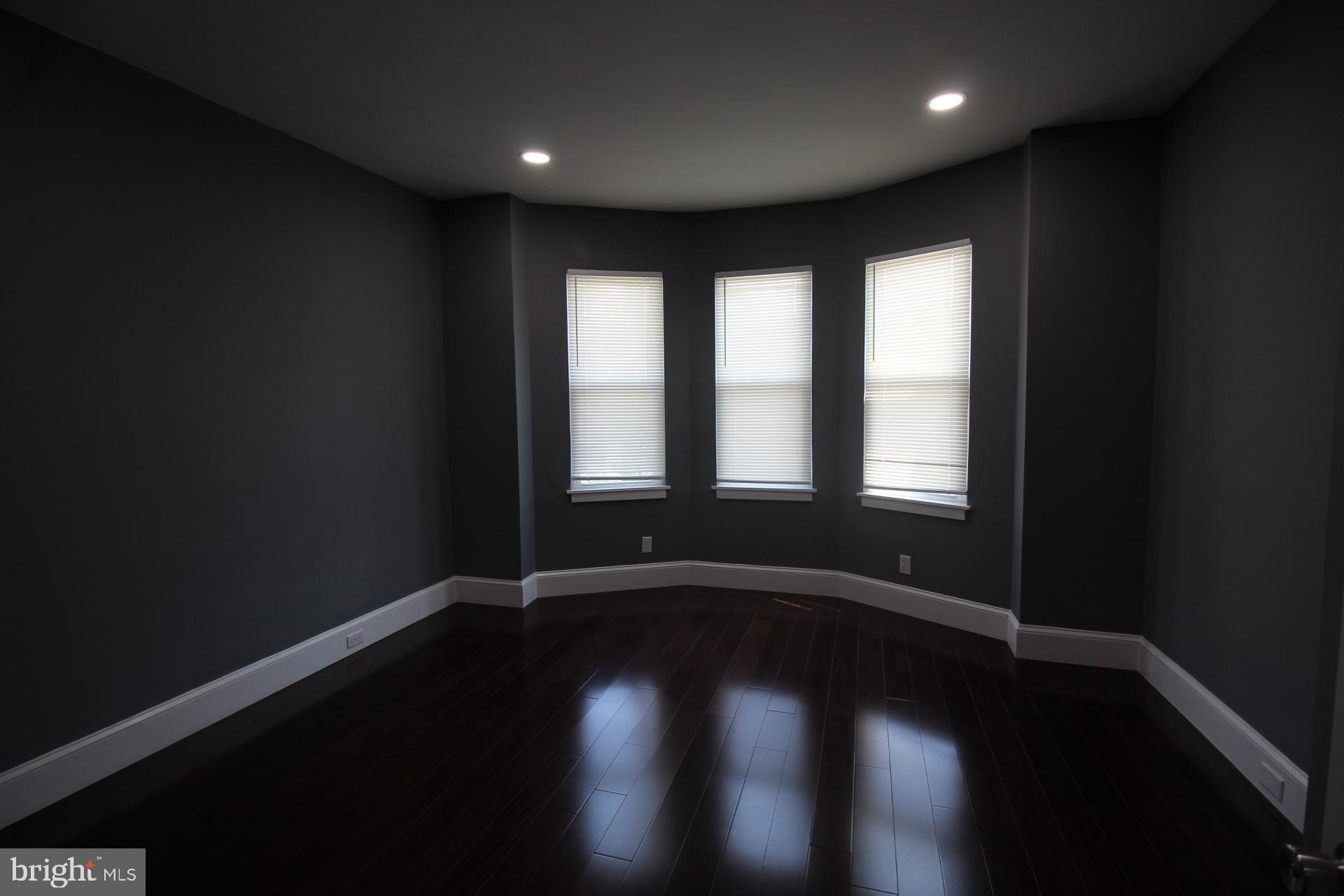 3086 Memphis Street Philadelphia, PA 19134 - Photo 9 of 18 a view of an empty room with wooden floor and a window