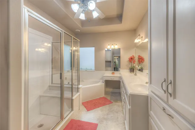 an empty room with a fan & a window