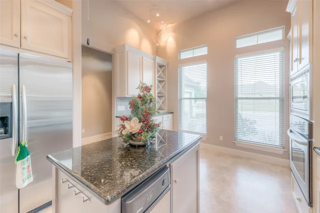 a view of kitchen with furniture and natural light
