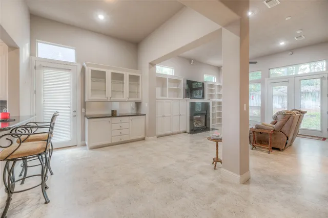 a living room with furniture and a view of kitchen
