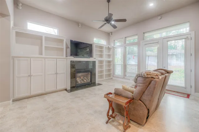 an empty room with furniture and a ceiling fan